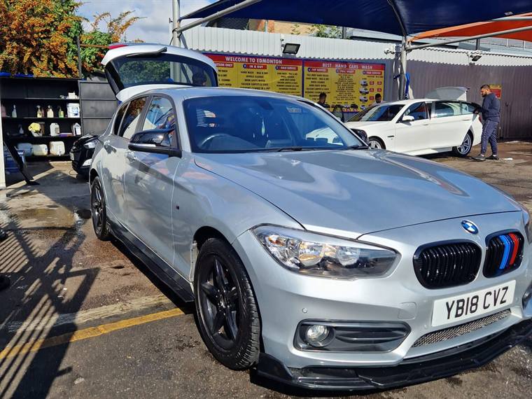 Silver BMW 1 Series finished and parked outside the workshop